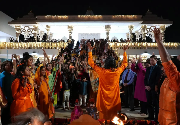 A group of people in a room with a person in an orange robe

AI-generated content may be incorrect.