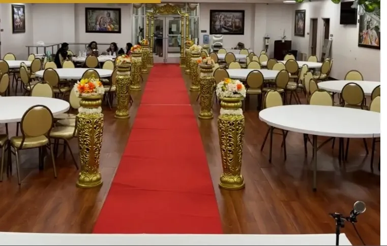 Seva Kunj elegantly set up for a wedding reception, featuring lush floral arrangements, crystal chandeliers, and a beautifully decorated stage for a memorable celebration