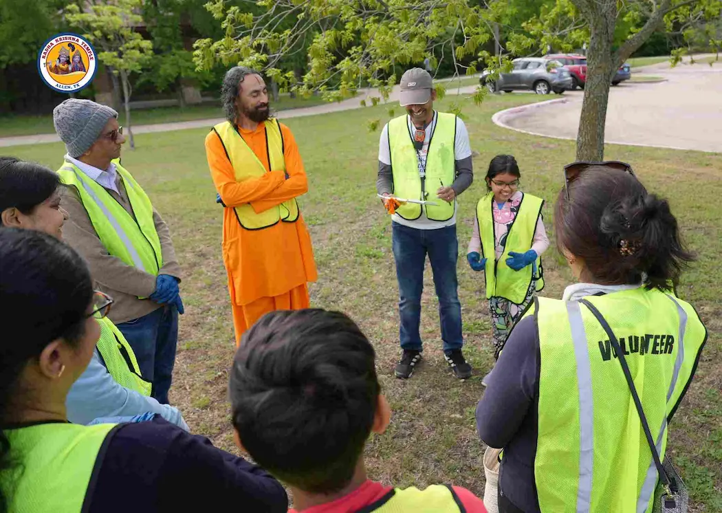 Group of volunteers meeting outdoors for seva service based on Bhagavad Gita teachings.