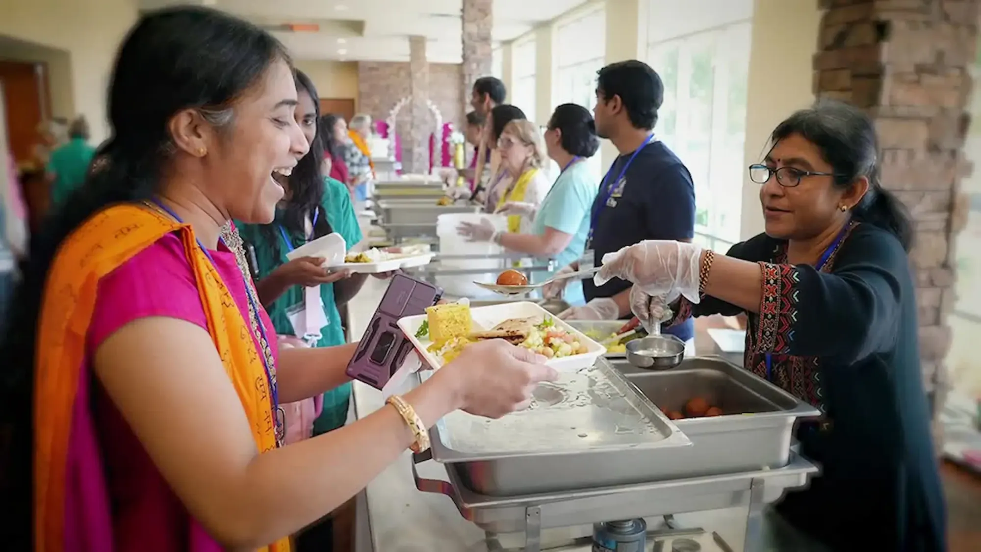 Volunteers serving prasad at temple as an act of selfless service.