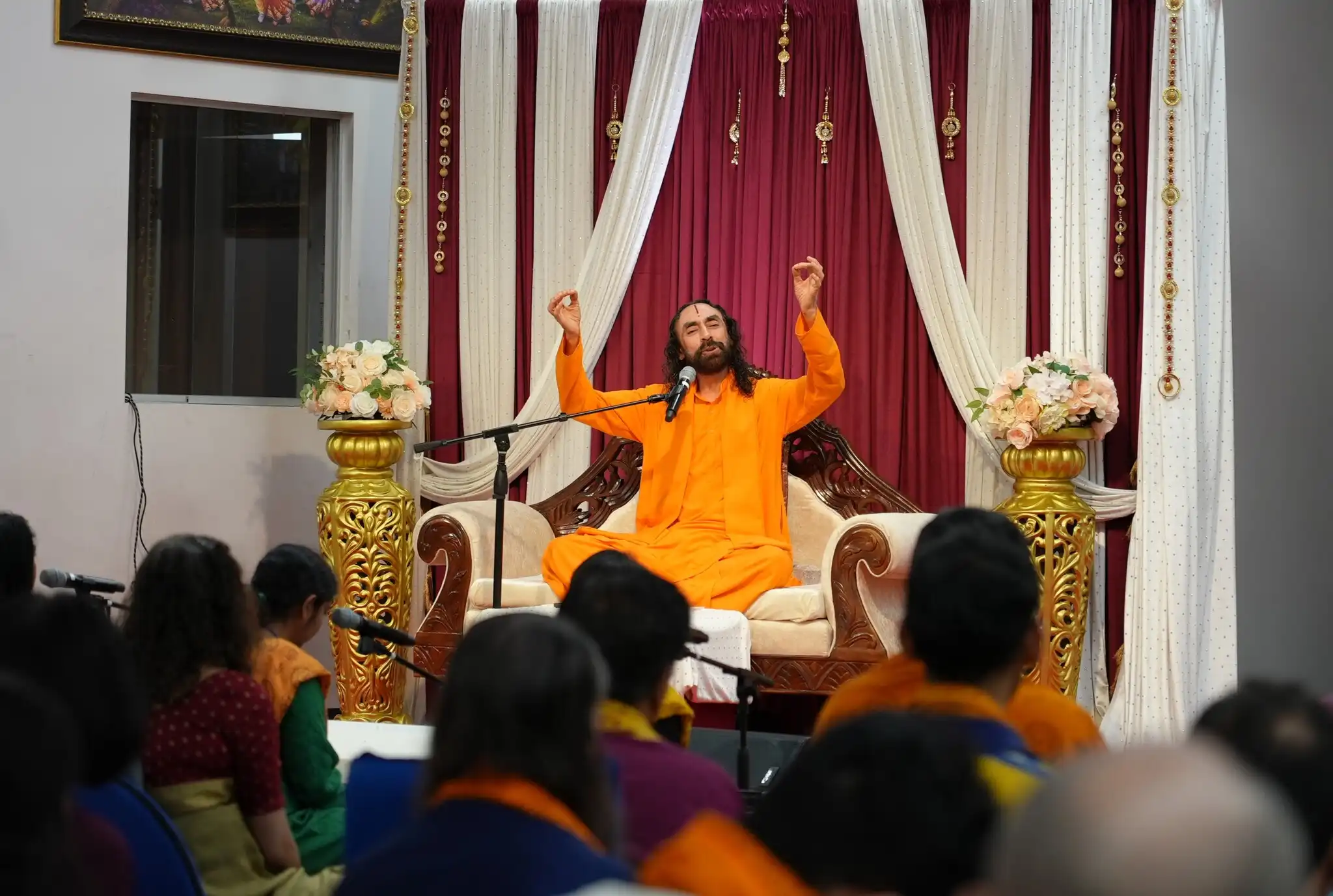 Devotees immerse in devotion as Swami Mukundananda guides a soulful kirtan and satsang session.