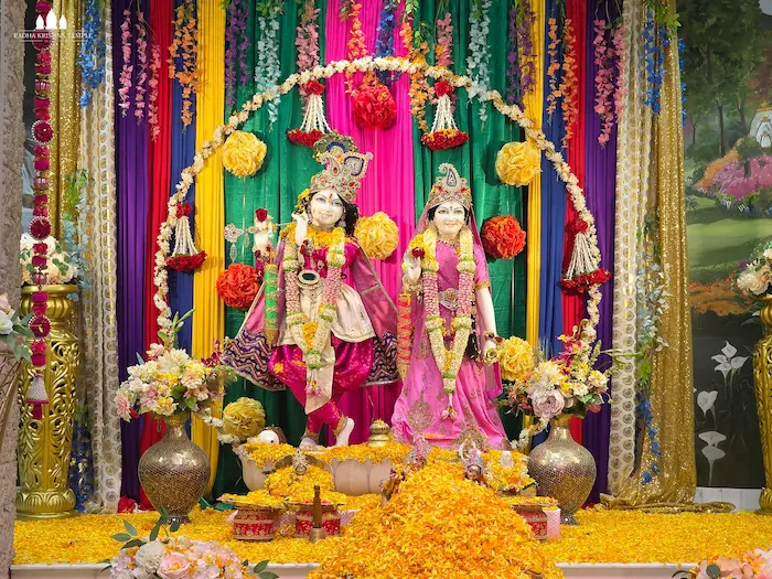 Radha Krishna deities beautifully decorated with colorful flowers and garlands at Radha Krishna Temple Dallas