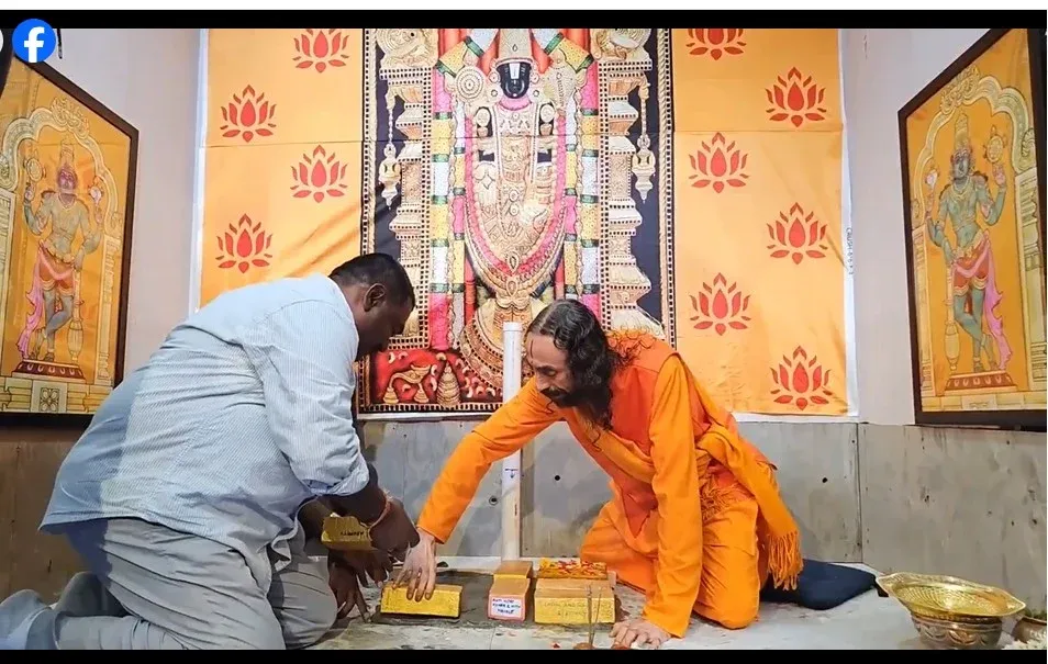 Swami Mukundananda and a devotee kneel near an altar while placing sacred bricks for the Sri Venkateshwara Swamy Prana Pratistha preparations at Radha Krishna Temple.