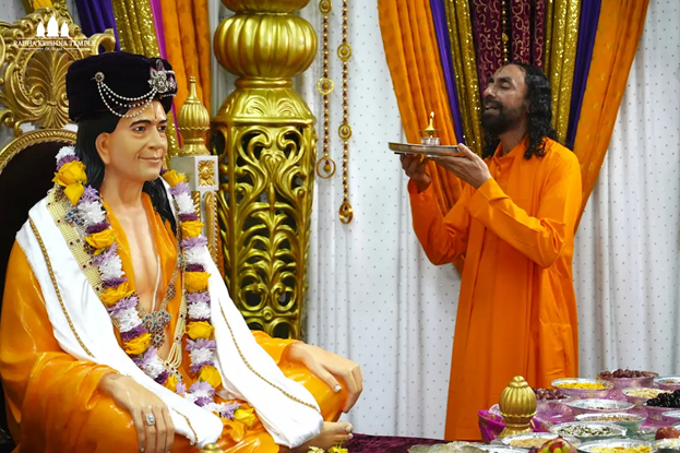Swami Mukundananda offers aarti to Jagadguru Shri Kripaluji Maharaj in a devotional temple setting, symbolizing Guru Grace, reverence, surrender, and the sacred bond between Guru and disciple.