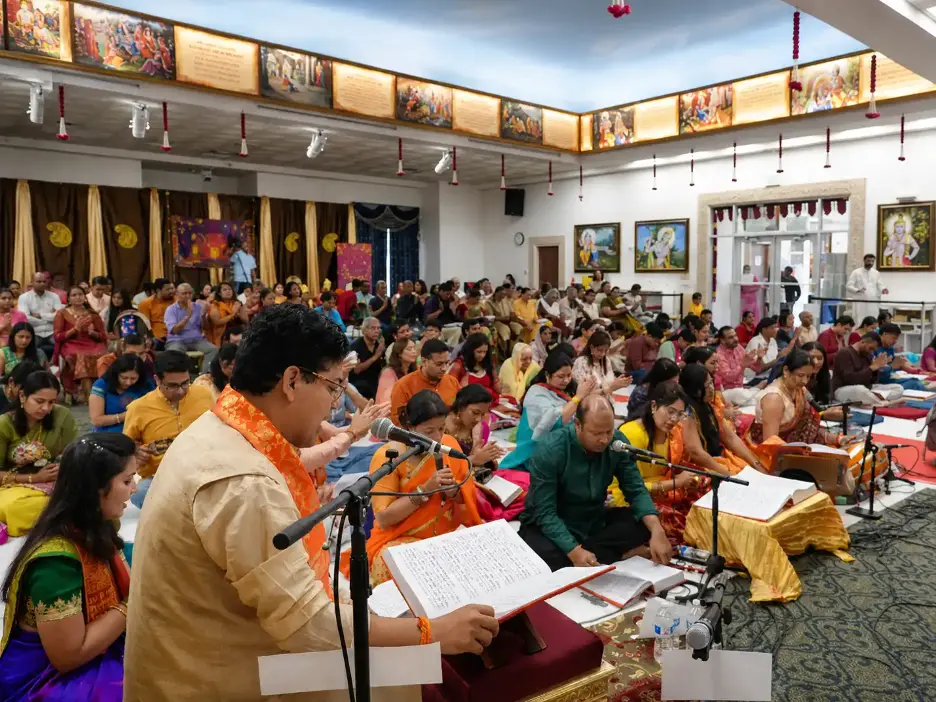 Devotees seated inside Radha Krishna Temple of Dallas participate in Bhagavad Gita Parayanam with scriptures and microphones