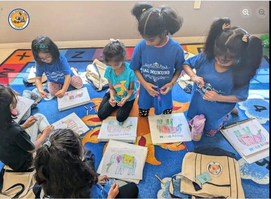 Children wearing Bal-Mukund shirts color drawings and participate in an arts-and-crafts activity during the Dallas Spiritual Retreat