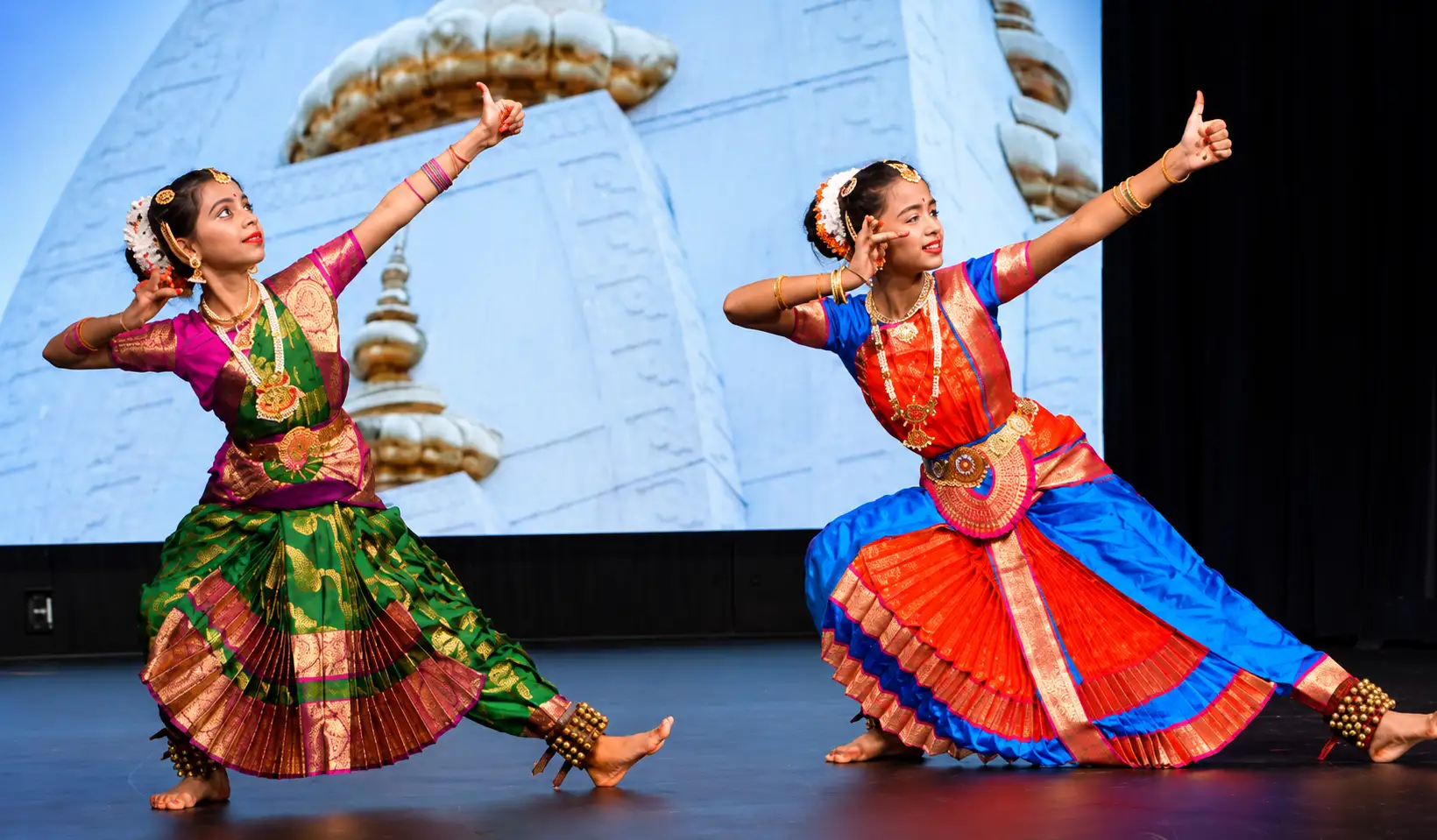 Two young dancers performing a traditional Indian classical dance during Janmashtami celebrations at Radha Krishna Temple of Dallas