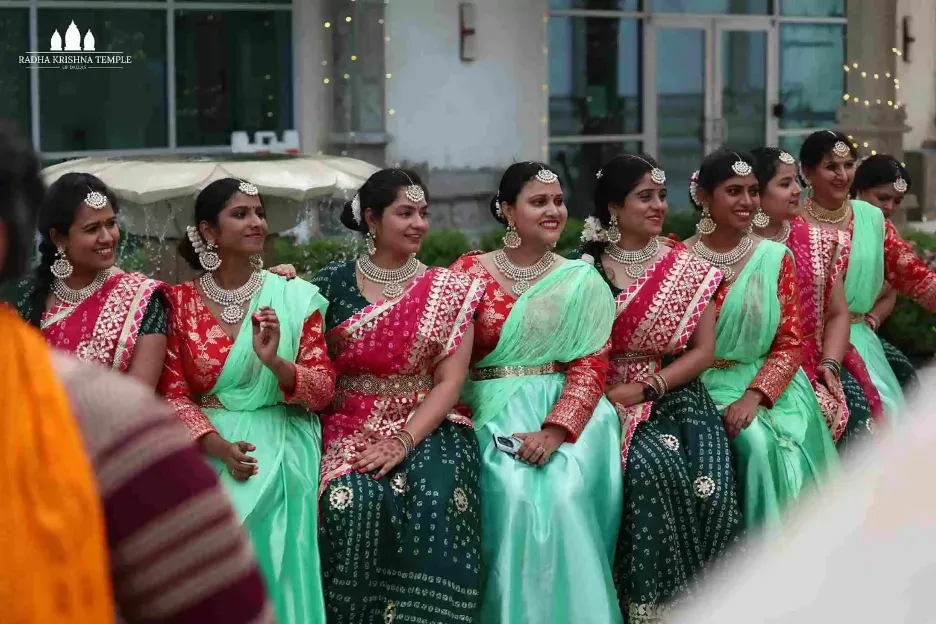 Women in coordinated traditional attire participating in a cultural program during Ganesh Mahotsav celebrations
