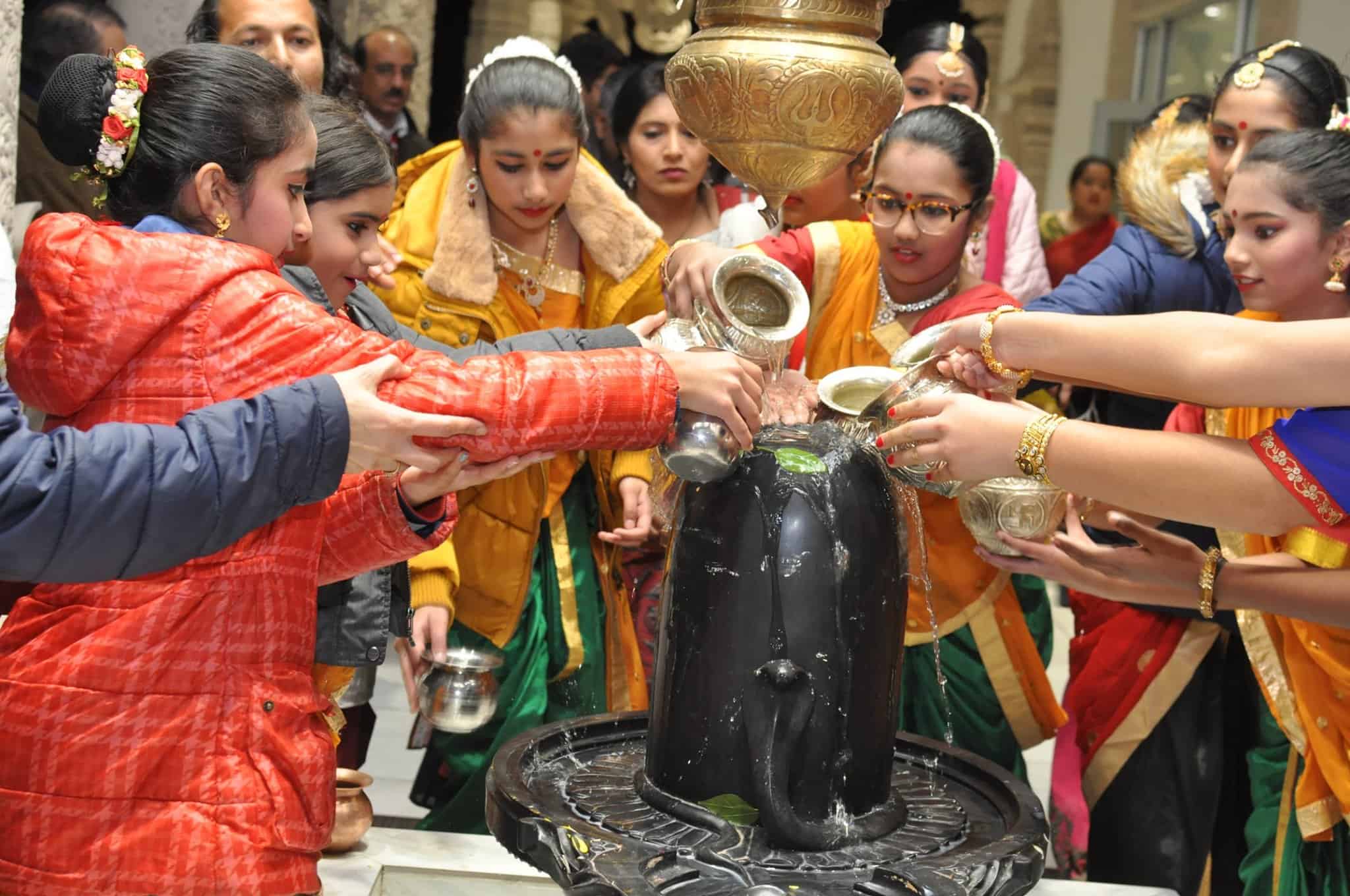 Group of people doing abhishek for Shiv Ling